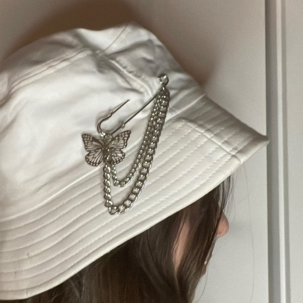 White Bucket hat with safety pin charm with chain and butterfly